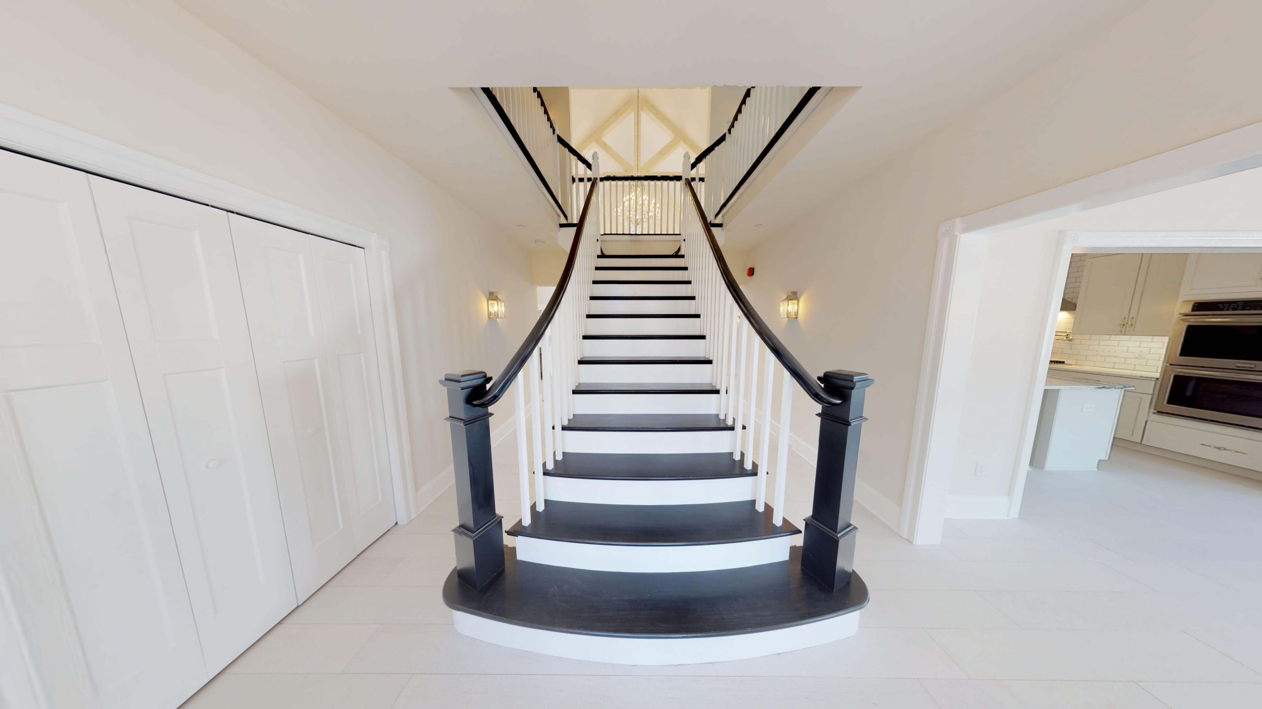 grand starcase in the entrance to a custom home