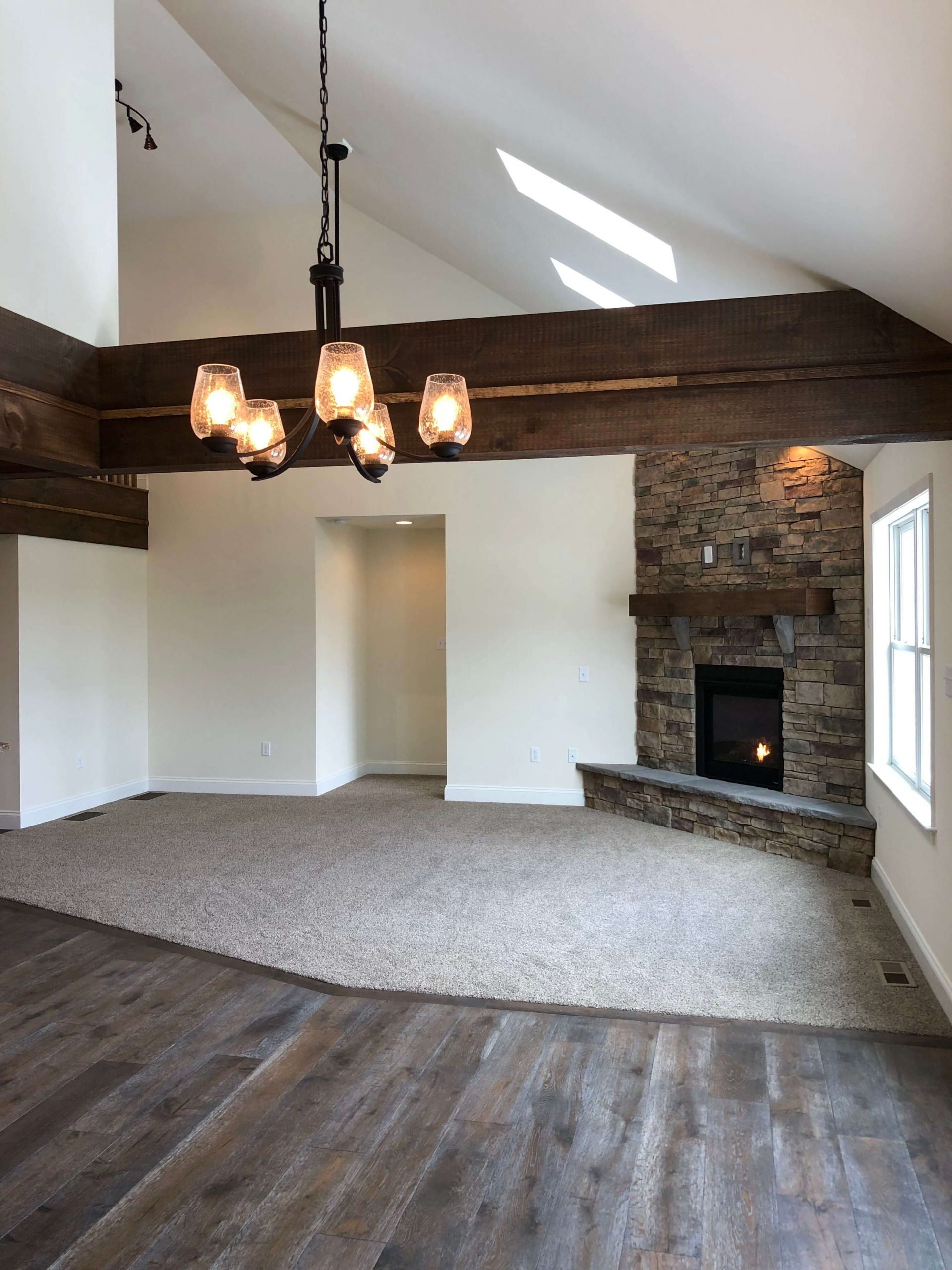 finished custom family room or den with chandelier and fireplace