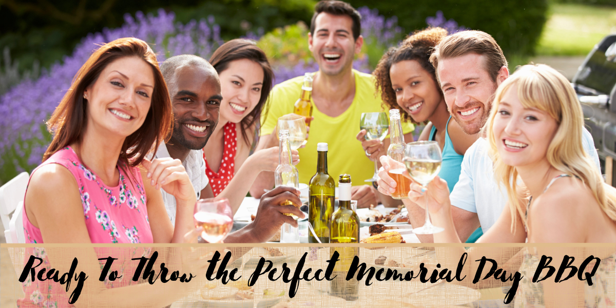 group of adults around a table outdoors celebrating memorial day